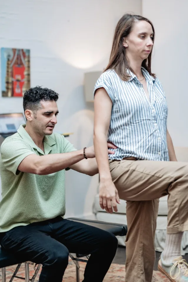 Dr. Daniel Goodman evaluating patient posture and movement in Lower Manhattan